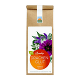 Bio Kräutertee Drachenglut in brauner Papiertüte mit weißem Etikett, rotem Rundlabel und kräftigem Kräuter-/Blütenmotiv; Hinweis ‚kraftvoll & wärmend‘.