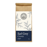 Earl Grey Creamy – Schwarzer Tee der Mühle Ahrenshoop in brauner Papierverpackung mit dunkelblauem Etikett.